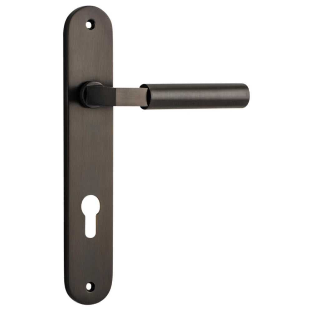 Pair of Iver Berlin lever door handles on oval backplates, featuring sleek metal finish and modern design for stylish interior doors.