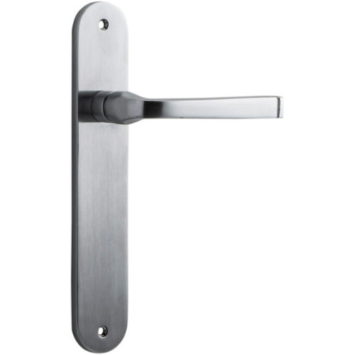 Pair of Iver Annecy lever door handles on oval backplates, featuring a sleek, modern design in polished finish.