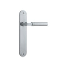 Pair of Iver Berlin lever door handles on oval backplates, showcasing sleek modern design in polished metal finish.