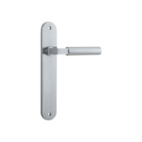 Pair of Iver Berlin lever door handles on oval backplates, showcasing sleek modern design in polished metal finish.