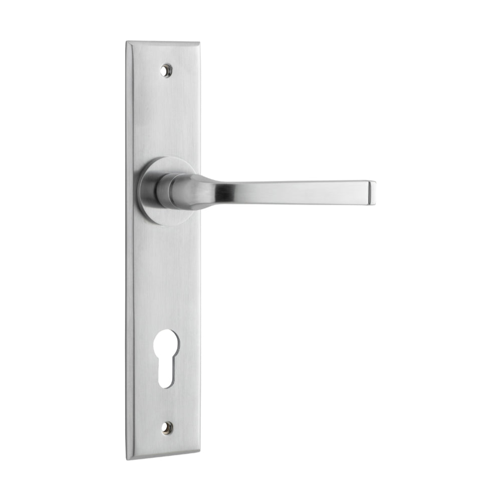 Pair of Iver Annecy lever door handles on chamfered backplates, showcasing elegant brass finish and modern design.