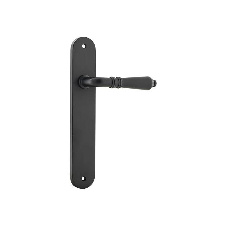 Pair of Iver Sarlat lever door handles on oval backplates, featuring a sleek, modern design for interior doors.
