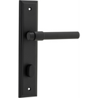 Pair of Iver Helsinki lever door handles on stepped backplates, showcasing sleek, modern design in a close-up view.