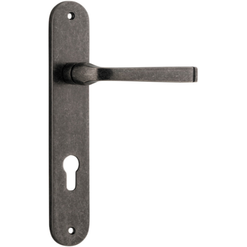 Pair of Iver Annecy lever handles on oval backplates, featuring elegant brass finish and classic design for interior doors.