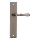 Pair of Iver Sarlat lever door handles on stepped backplate, showcasing elegant metal finish and modern design.