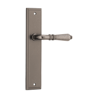 Pair of Iver Sarlat lever door handles on stepped backplate, showcasing elegant metal finish and modern design.