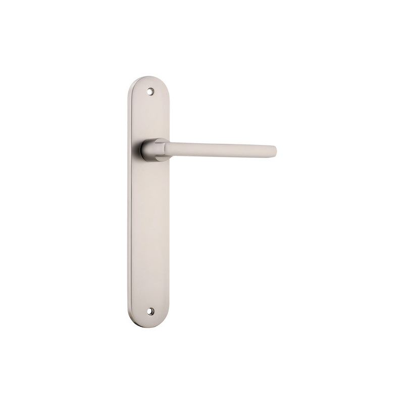 Pair of Iver Baltimore lever door handles on oval backplates, featuring a sleek, modern design in polished finish.
