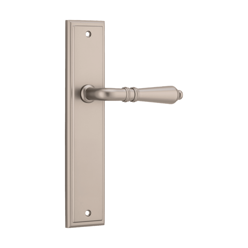 Pair of Iver Sarlat lever handles on stepped backplates, featuring classic brass finish and elegant design for interior doors.