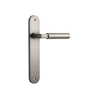 Pair of Iver Berlin lever door handles on oval backplates, showcasing sleek metal design and polished finish.