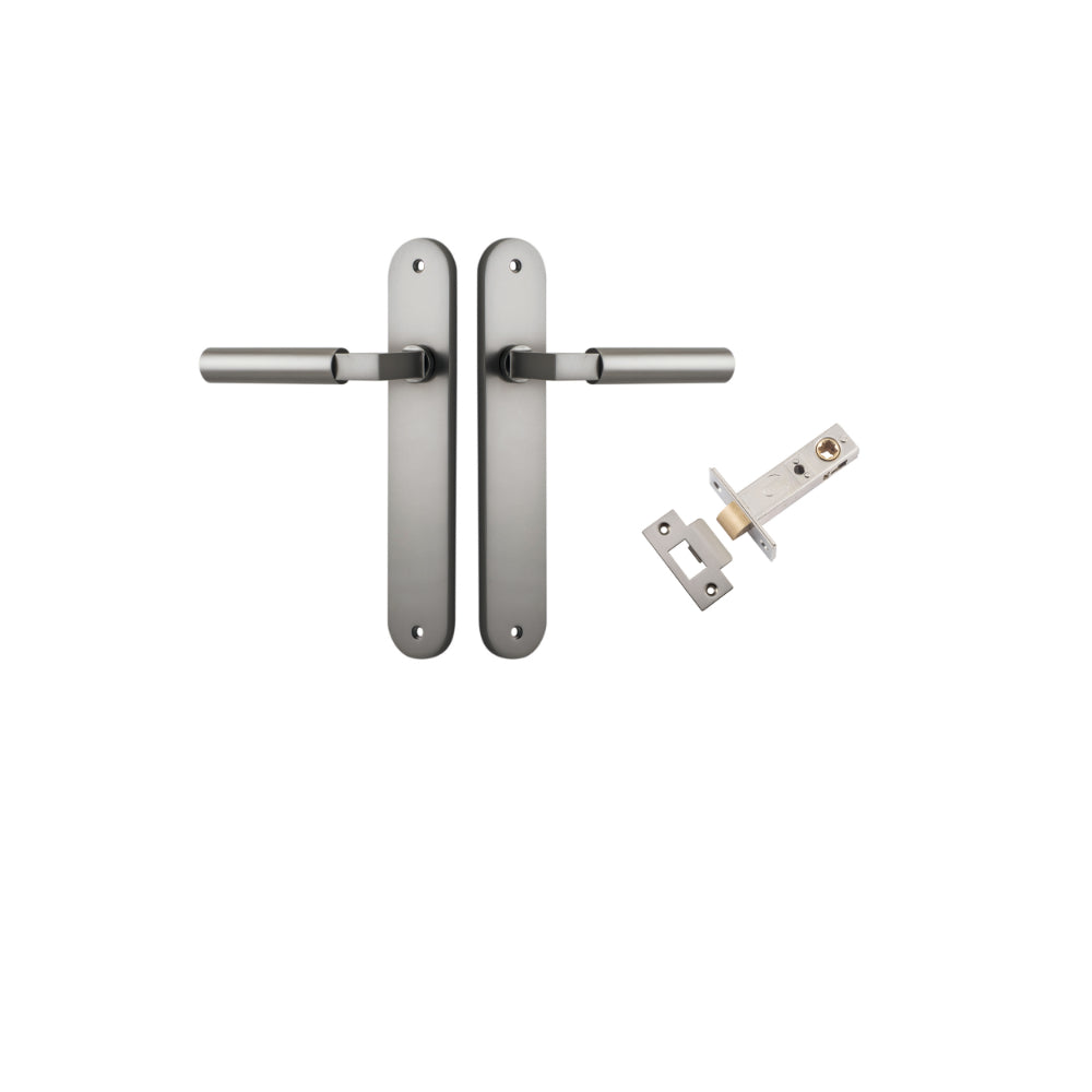 Pair of Iver Berlin lever door handles on oval backplates, featuring modern brass finish for stylish interior doors.