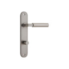 Pair of Iver Berlin lever door handles on oval backplates, featuring a sleek modern design in polished finish.