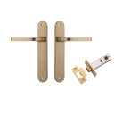 Pair of Iver Annecy lever door handles on oval backplates, featuring a sleek, modern brass finish for contemporary interior doors.