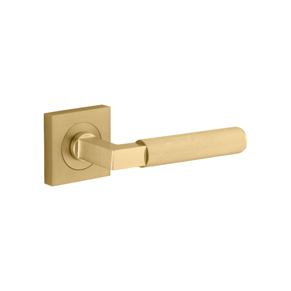 Pair of Iver Brunswick lever door handles on square rose, featuring a stylish and modern brass finish for interior doors.