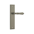 Pair of Iver Sarlat lever handles with stepped backplate for doors, showcasing elegant brass finish and detailed design.