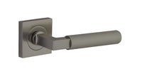 Pair of Iver Brunswick lever door handles on square rose, featuring classic brass finish and elegant design for interior doors.