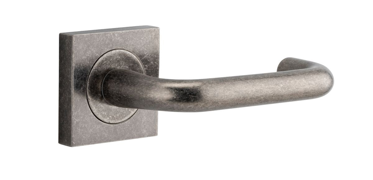 Pair of Iver Oslo Lever on Square Rose architectural hardware, polished metal finish, mounted on square rose plates.