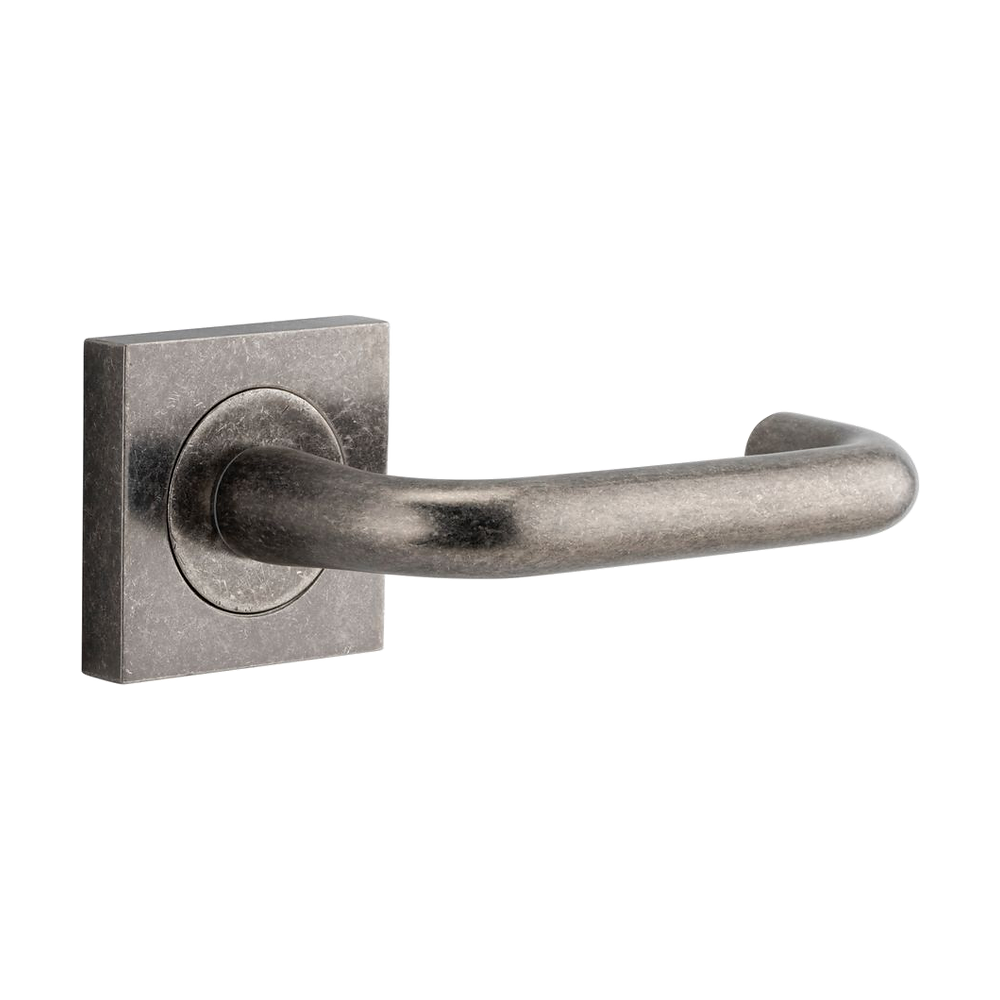 Pair of Iver Oslo Lever handles on square rose, architectural hardware with a sleek, modern design for doors.