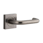 Pair of Iver Oslo Lever handles on square rose, architectural hardware with a sleek, modern design for doors.