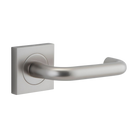Pair of Iver Oslo Lever handles on square rose, architectural hardware with modern design for doors.
