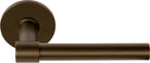 Pair of Formani ONE XL 15Ø lever handles on round rose, showcasing modern brass door hardware design.