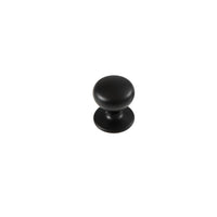 Momo New Hampton cabinet knob in dark blue, round ceramic with a smooth finish, mounted on a wooden cabinet door.