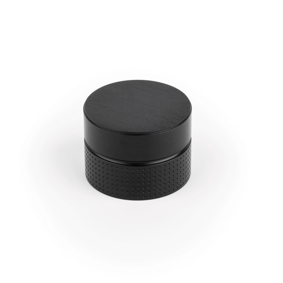 Momo POINT cabinet knob in black with a sleek, modern design, mounted on a wooden cabinet door.