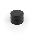 Momo POINT cabinet knob in black with a sleek, modern design, mounted on a wooden cabinet door.