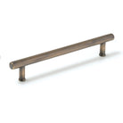 Momo STRANO cabinet pull handle with brushed aluminum finish, sleek modern design, mounted on a wood cabinet door.