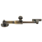 Windsor restrictor stay in round design, black finish, mounted on window frame for safety and security.