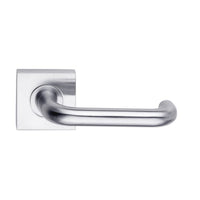 DormaKaba Madinoz Lever 018 door handle with sleek metal finish and ergonomic design on a modern door.