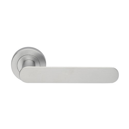 Manital Ratio door handles set with sleek, modern design and polished finish, installed on a wooden door.