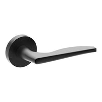 Castile door handle by Style Finish Doorware, black matte finish, mounted on door with sleek, modern design and ergonomic grip.
