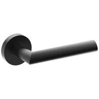 Black COMO door handle by Style Finish Doorware installed on a door, showcasing sleek modern design and ergonomic shape.