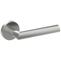 Stainless steel COMO door handle from Style Finish Doorware mounted on a door, showcasing sleek modern design.