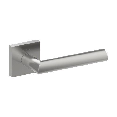 Stainless steel COMO door handle by Style Finish Doorware mounted on a door with a sleek, modern design.