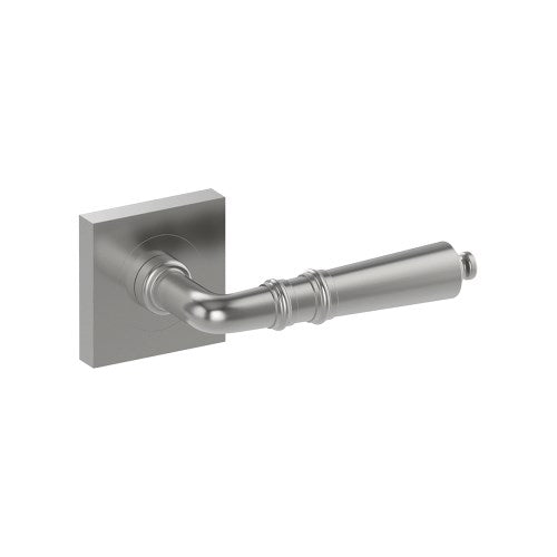 Stainless steel Latina door handle by Style Finish Doorware mounted on a door, featuring sleek modern design with a curved lever.