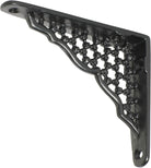 Decorative Tradco ornate shelf bracket in black with intricate scrollwork, mounted on a wooden shelf for support.