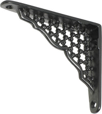 Decorative Tradco ornate shelf bracket in black with intricate scrollwork, mounted on a wooden shelf for support.